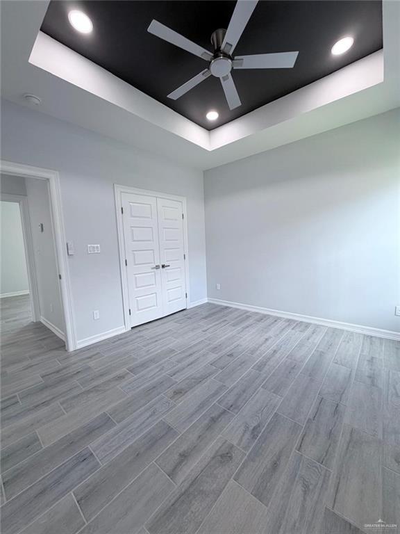 1724 Clinton Street Harlingen, TX 78550 - Photo 10 of 23 an empty room with wooden floor and windows
