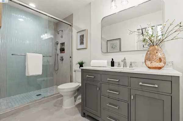 a bathroom with a sink a toilet and shower