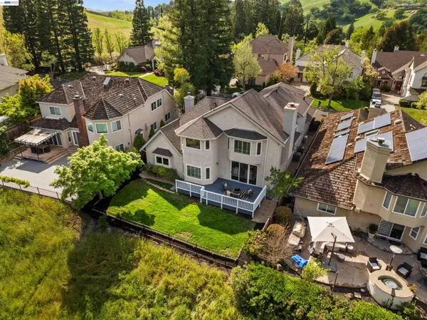 an aerial view of a house with a garden and lake view