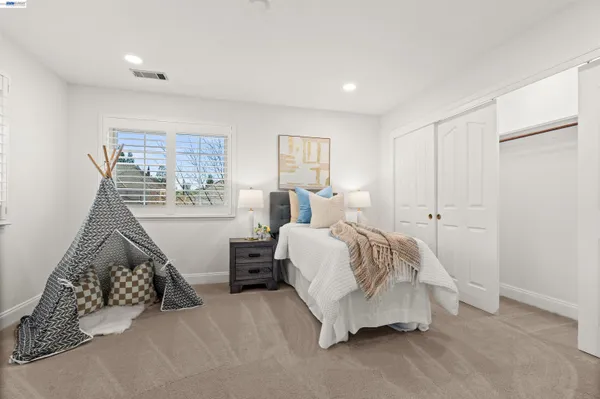 a bedroom with a bed and a lamp