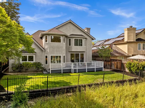 a view of a house with swimming pool and a yard