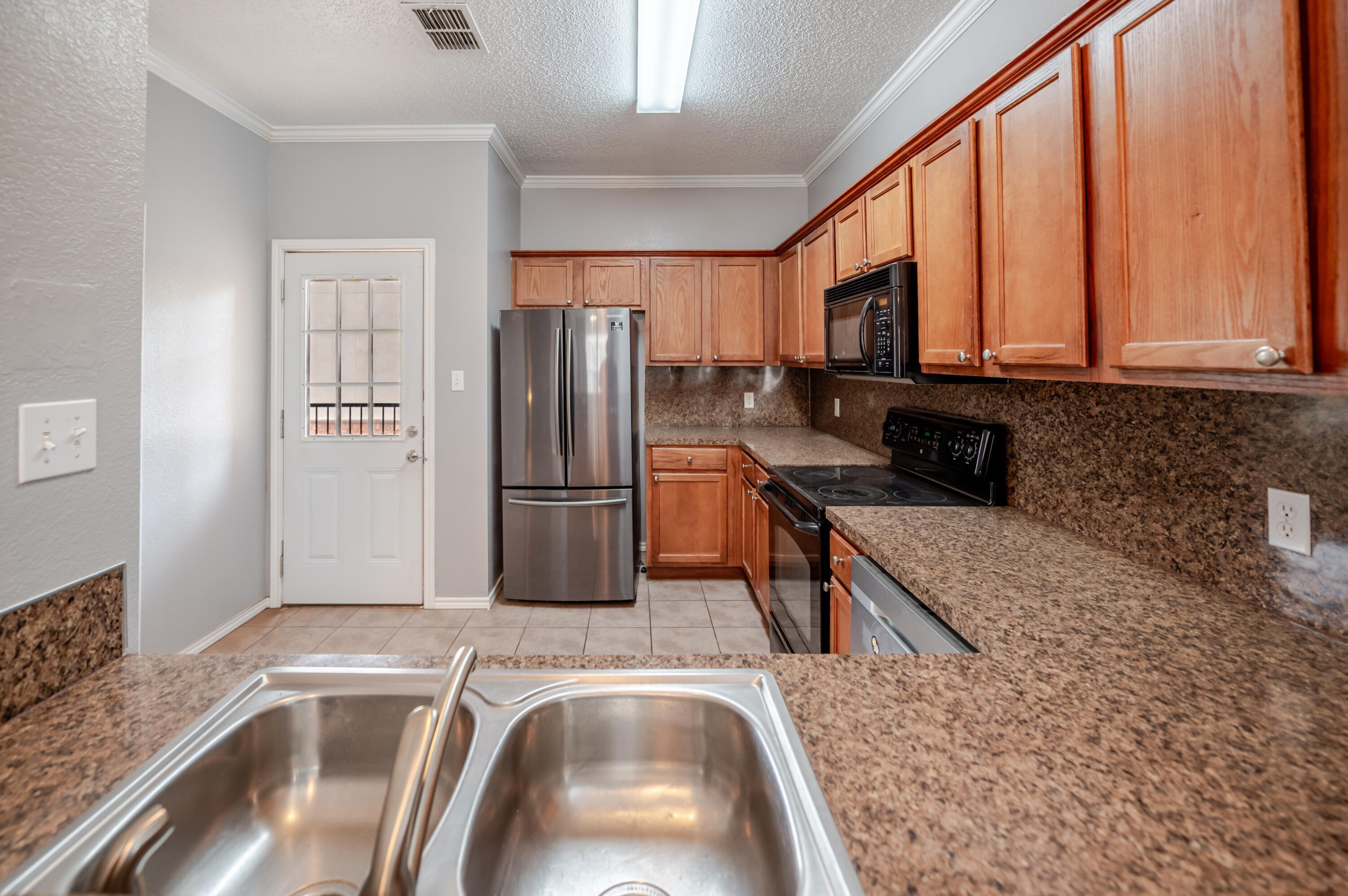 2111 Main Street, Unit 1 Lubbock, TX 79401 - Photo 6 of 36 a kitchen with a refrigerator sink and stove