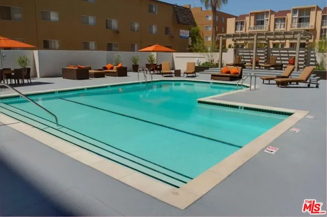 a swimming pool with outdoor seating and yard