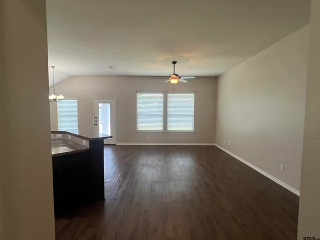 a view of a room with wooden floor and window