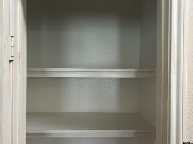 a kitchen with kitchen island granite countertop a stove top oven a sink dishwasher and wooden cabinets