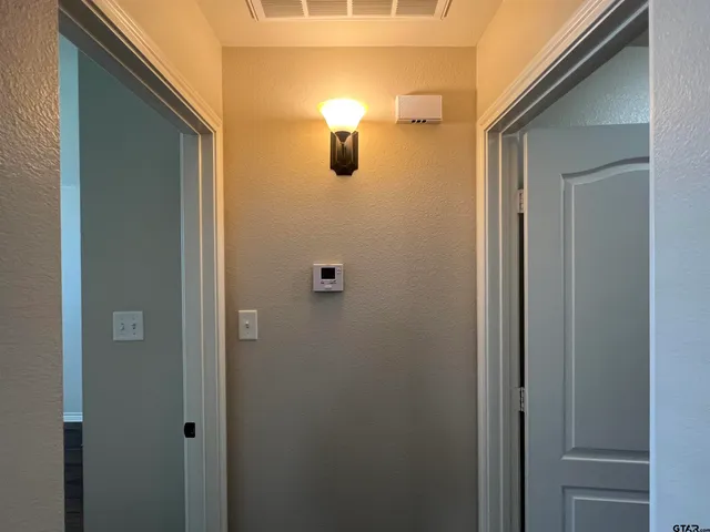 a view of a room with wooden floor fan and windows