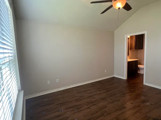 an empty room with wooden floor and closet