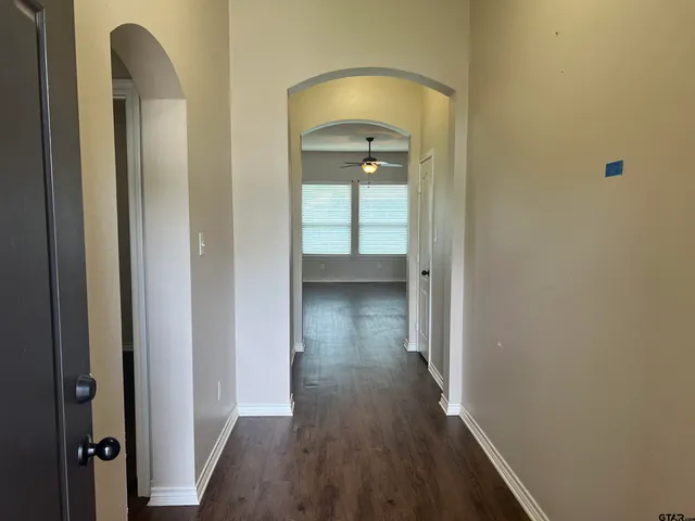 a view of a hallway with wooden floor