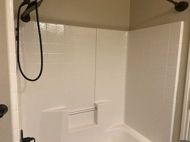 a bathroom with a bathtub and a toilet