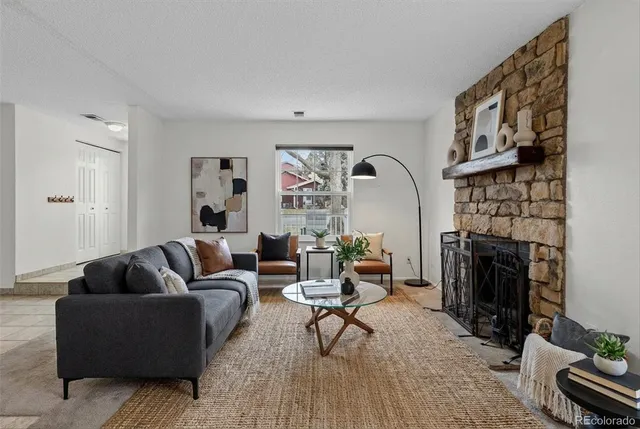 a living room with fireplace furniture and a fireplace