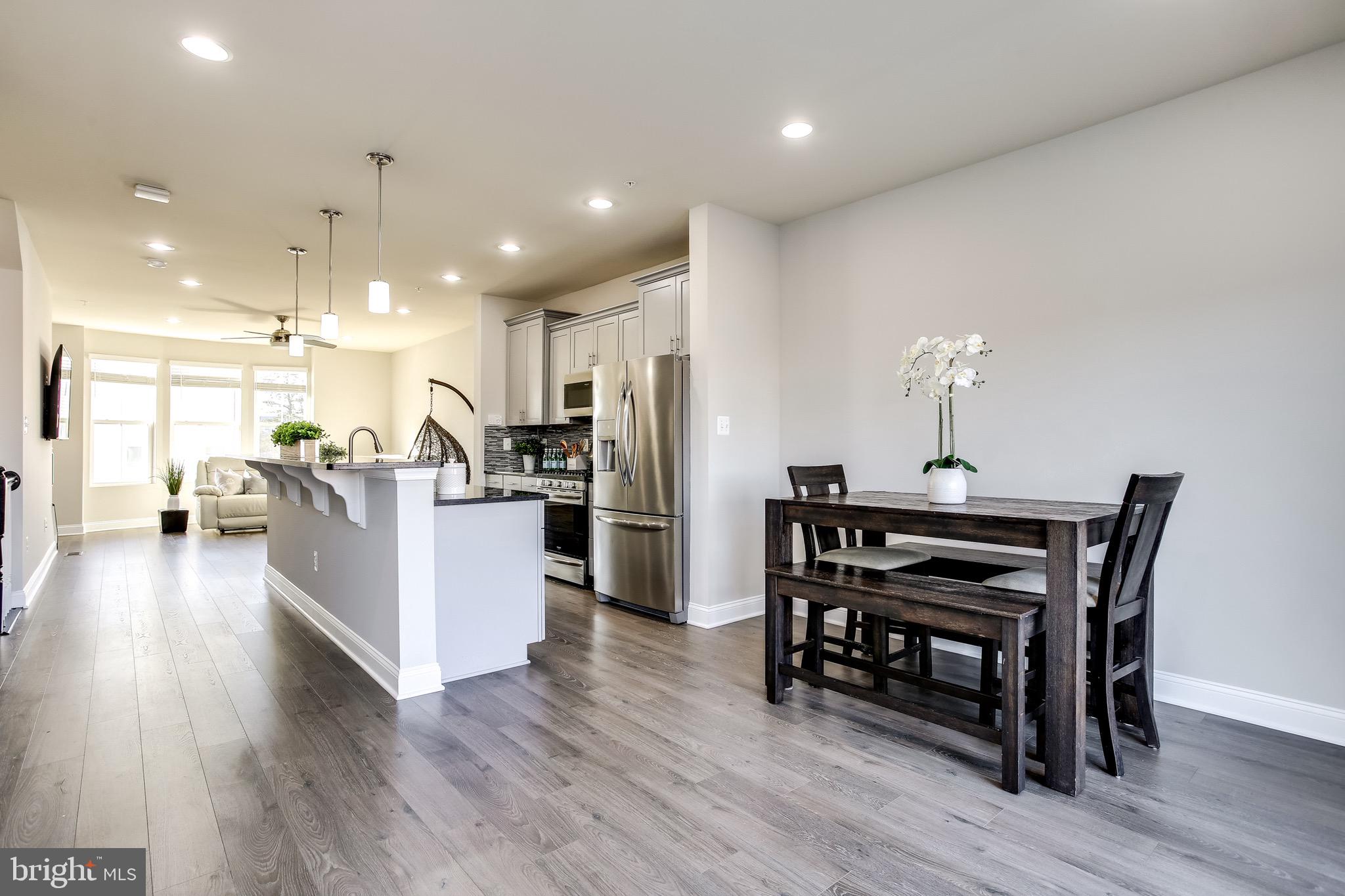 7034 Rackham Way Hanover, MD 21076 - Photo 11 of 42 Dining Area | Recessed Lights | Hardwood.