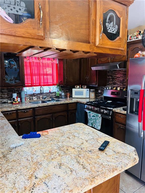 2349 Elaine Street Roma, TX 78584 - Photo 4 of 16 a kitchen with stainless steel appliances kitchen island granite countertop a stove a sink and a microwave