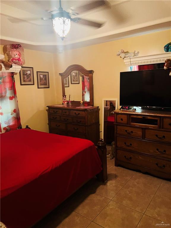 2349 Elaine Street Roma, TX 78584 - Photo 9 of 16 a bedroom with a bed and a flat screen tv