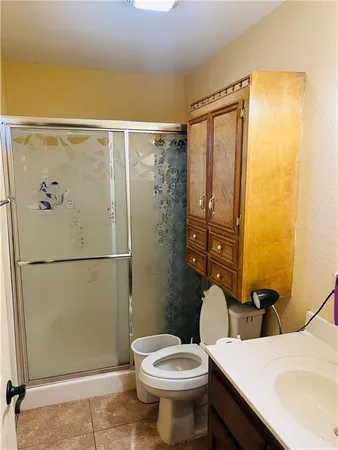 a bathroom with a sink mirror and toilet