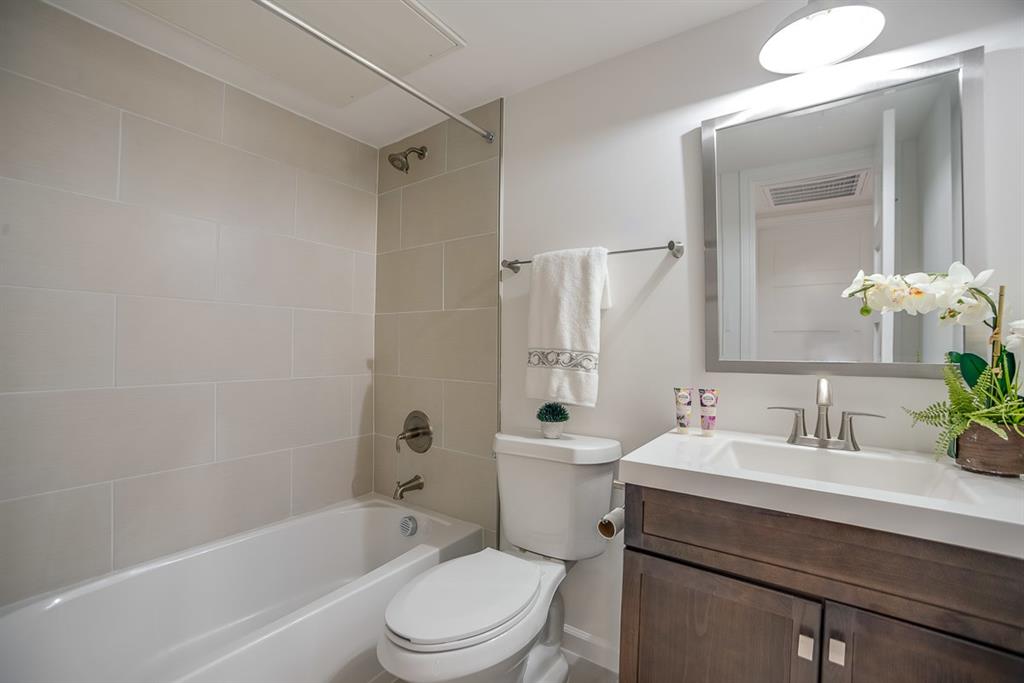 1809 Bennett Avenue, Unit 117 Dallas, TX 75206 - Photo 5 of 5 Full bathroom featuring toilet, tiled shower / bath, and vanity