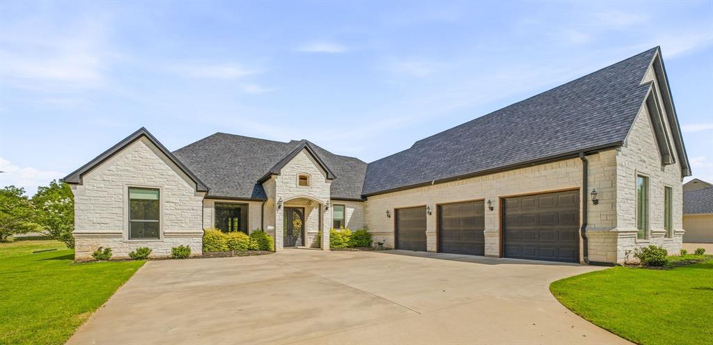 9503 Bellechase Road Granbury, TX 76049 - Photo 2 of 40 a front view of a house with a yard