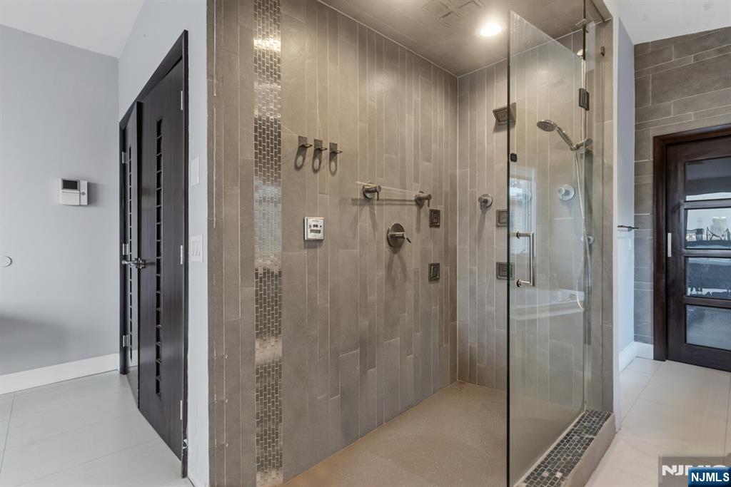 760 Undercliff Avenue Edgewater, NJ 07020 - Photo 23 of 48 a bathroom with a shower and a glass door