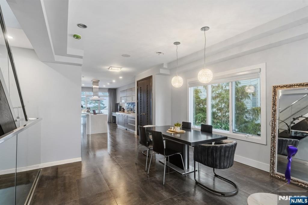 760 Undercliff Avenue Edgewater, NJ 07020 - Photo 24 of 48 a view of a dining room and livingroom with furniture wooden floor a chandelier