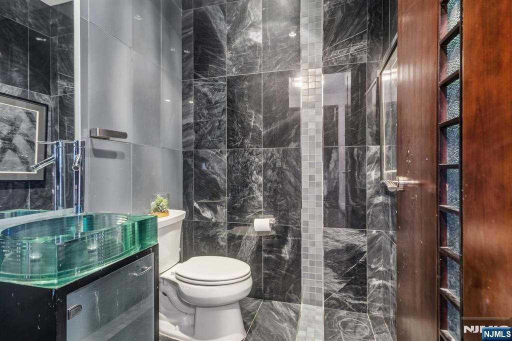 760 Undercliff Avenue Edgewater, NJ 07020 - Photo 26 of 48 a bathroom with a toilet and a shower