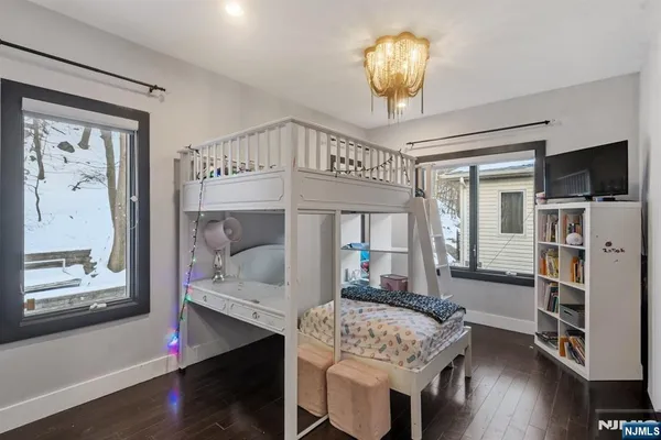 a view of a dining room with furniture a chandelier and wooden floor