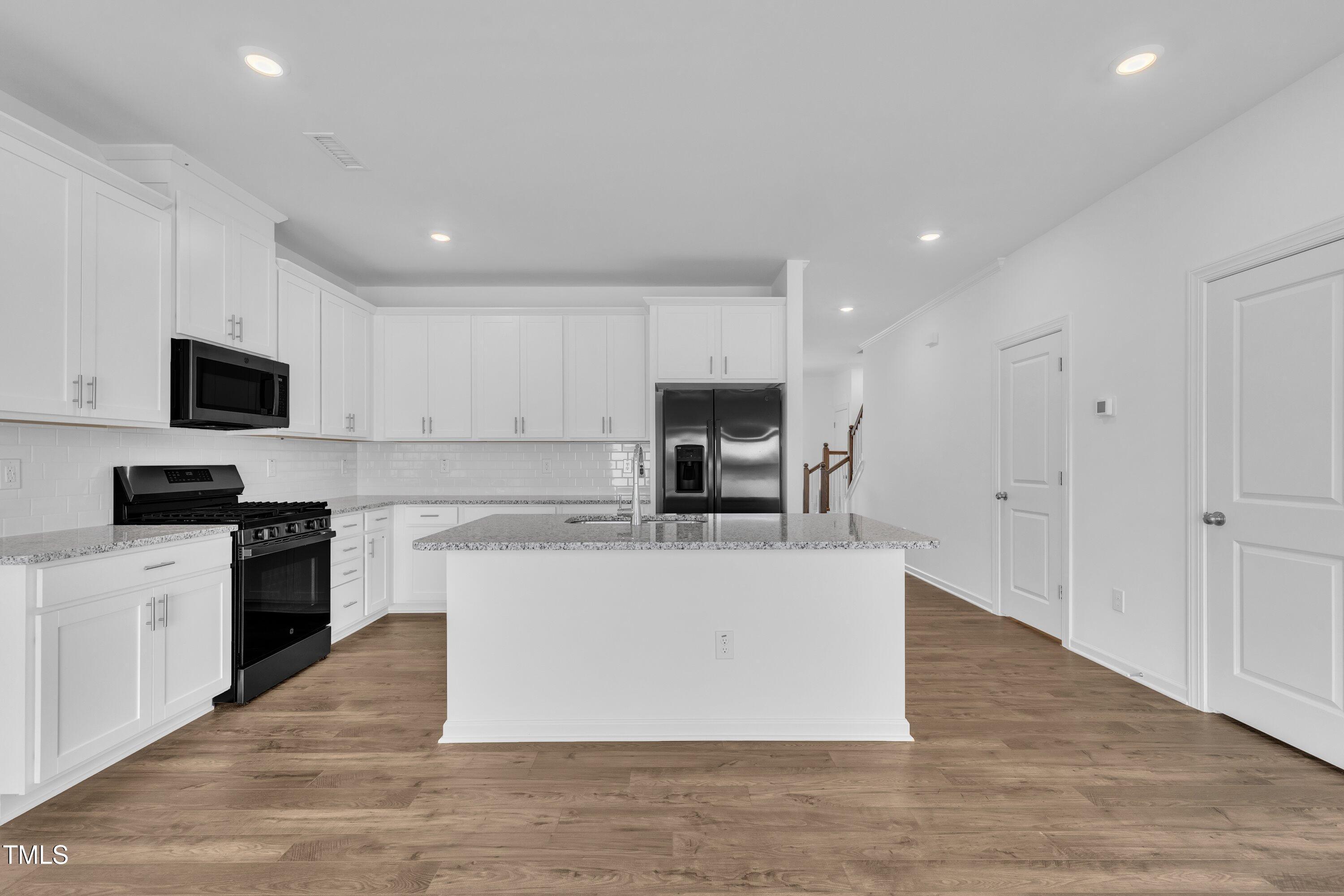 281 Hank Way Angier, NC 27501 - Photo 11 of 39 a view of kitchen with microwave stove top oven and cabinets