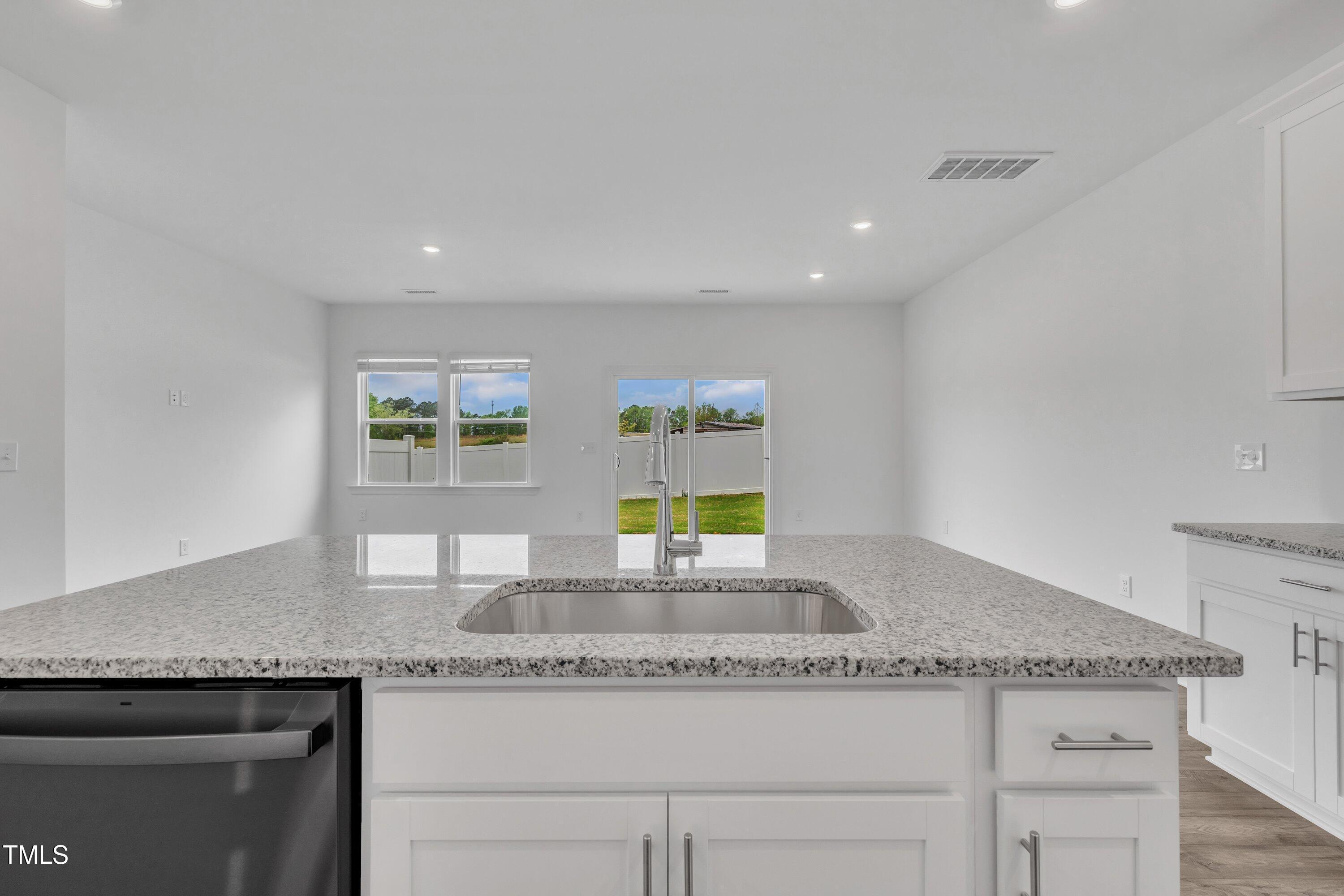 281 Hank Way Angier, NC 27501 - Photo 15 of 39 a kitchen with granite countertop counter top space and windows