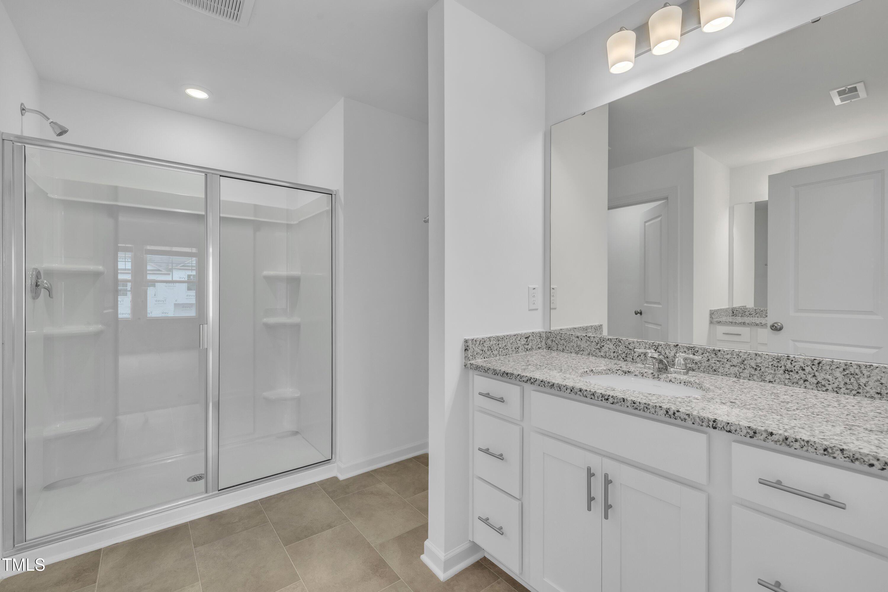 281 Hank Way Angier, NC 27501 - Photo 25 of 39 a bathroom with a granite countertop sink and mirror