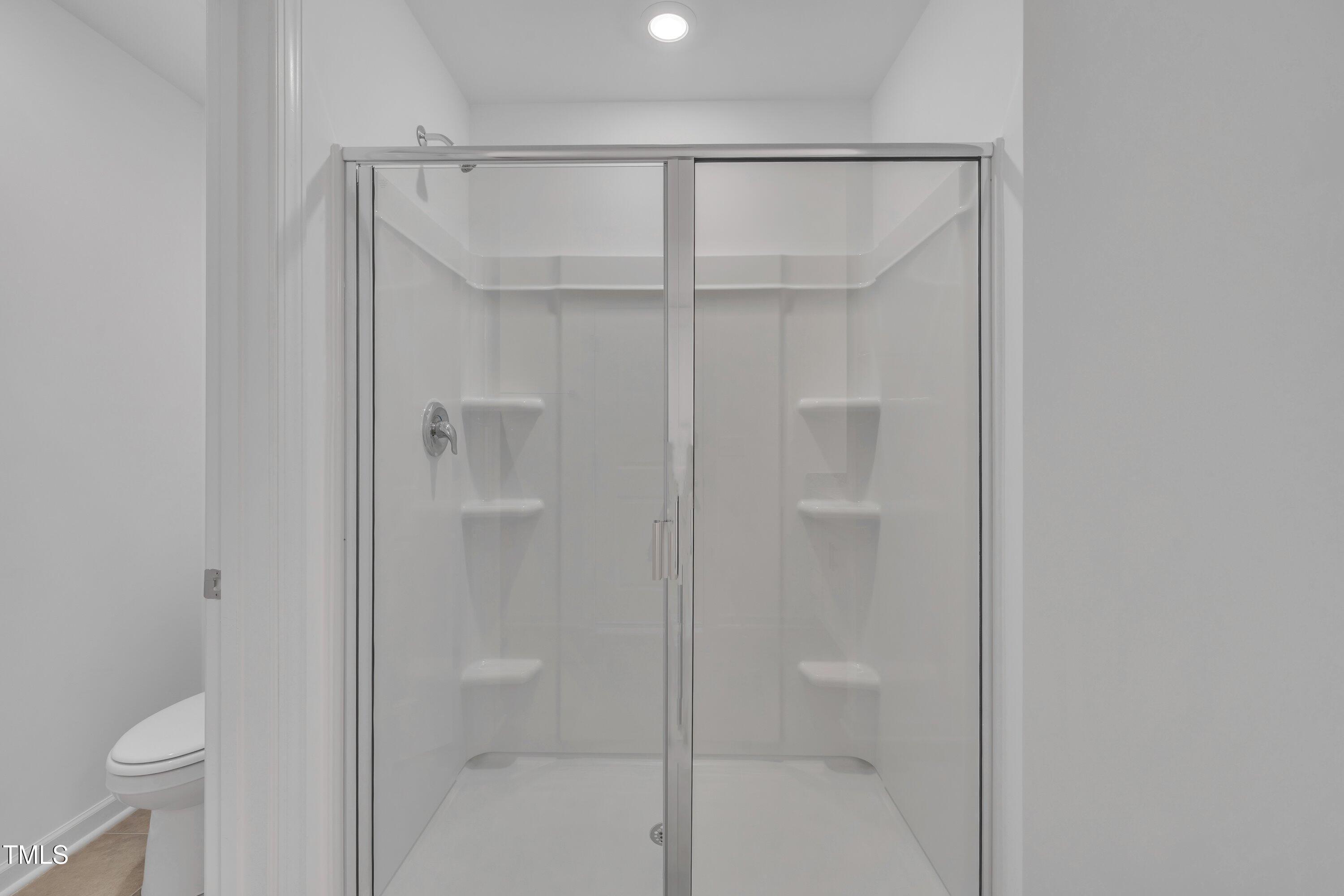 281 Hank Way Angier, NC 27501 - Photo 27 of 39 a bathroom that has a glass shower door