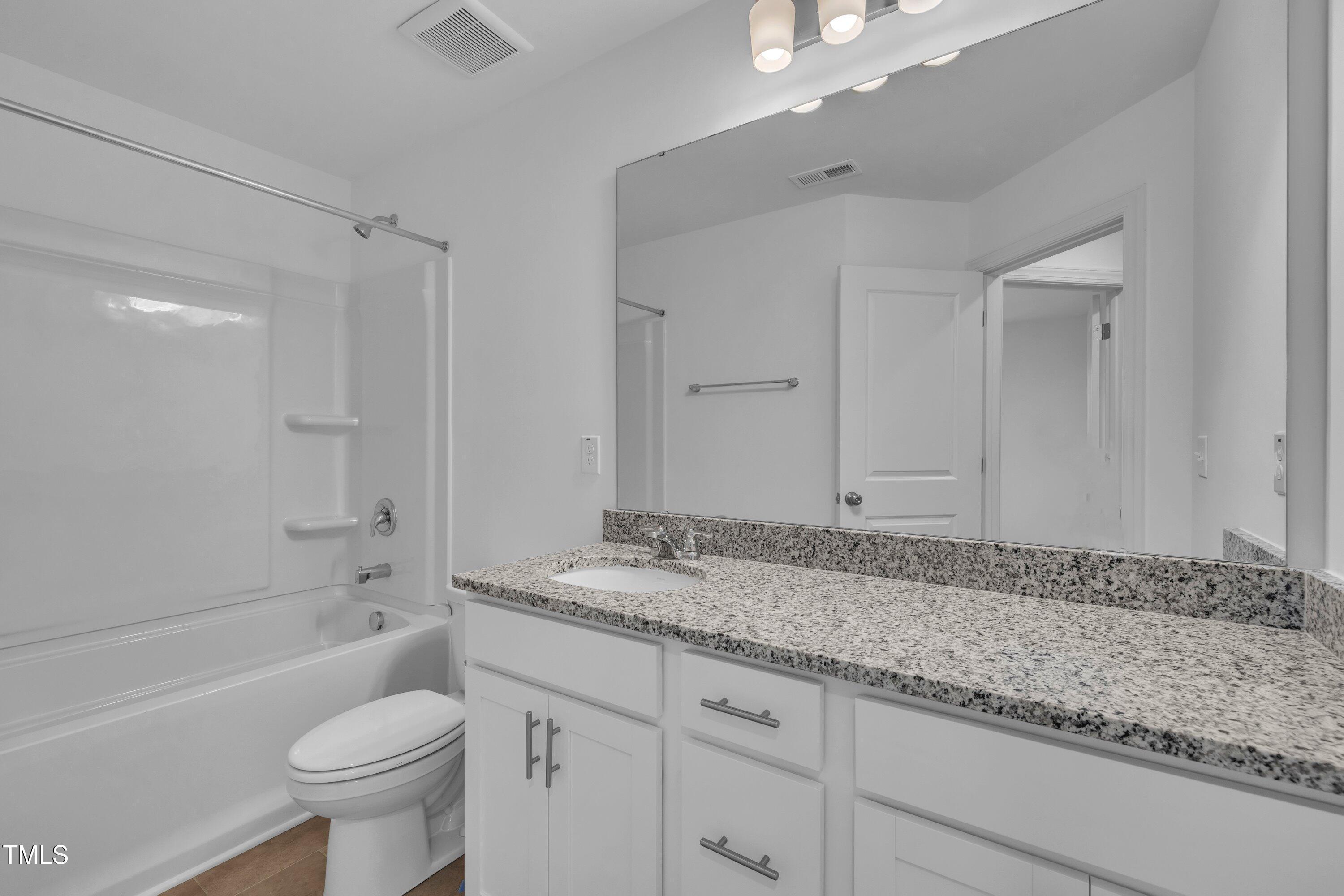 281 Hank Way Angier, NC 27501 - Photo 30 of 39 a bathroom with a granite countertop sink toilet and shower