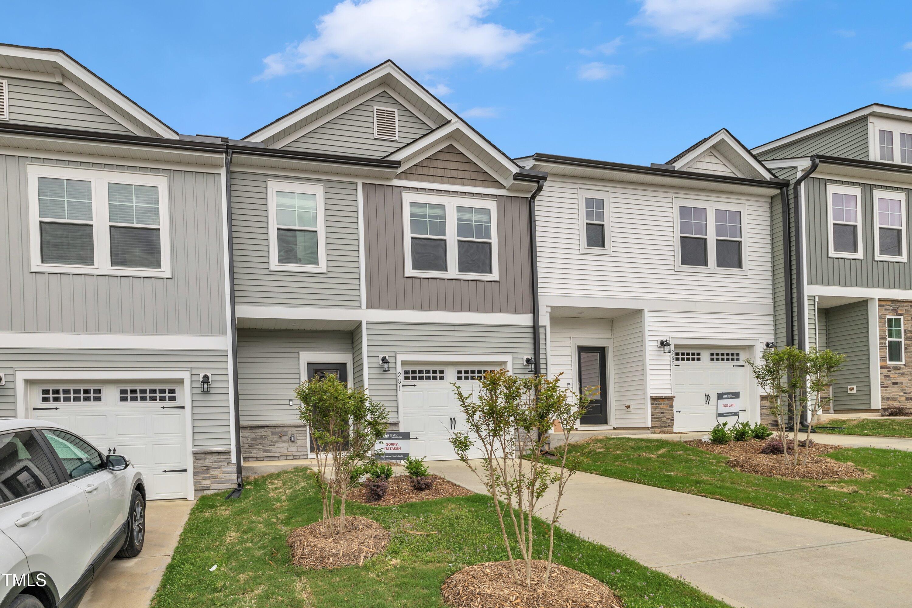 281 Hank Way Angier, NC 27501 - Photo 3 of 39 a front view of a house with a yard