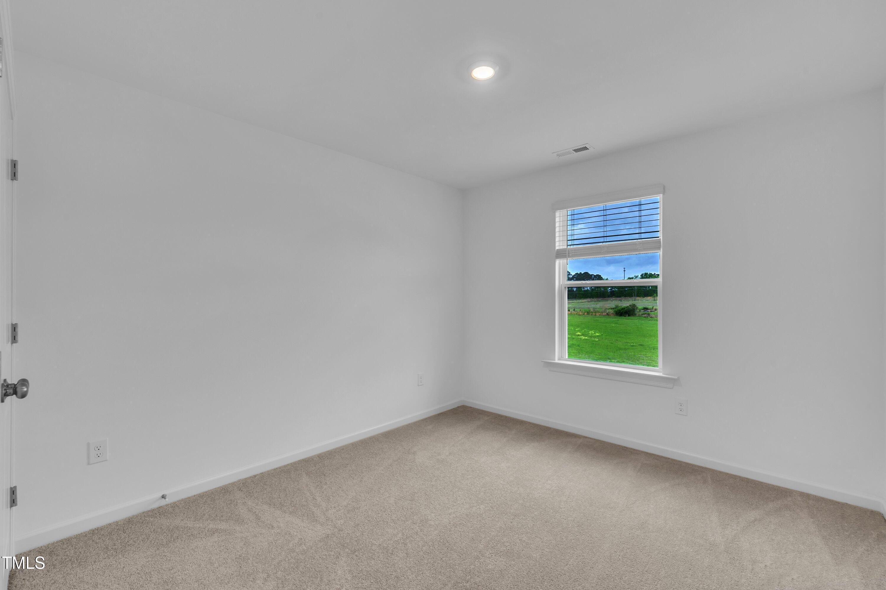 281 Hank Way Angier, NC 27501 - Photo 34 of 39 a view of an empty room with a window