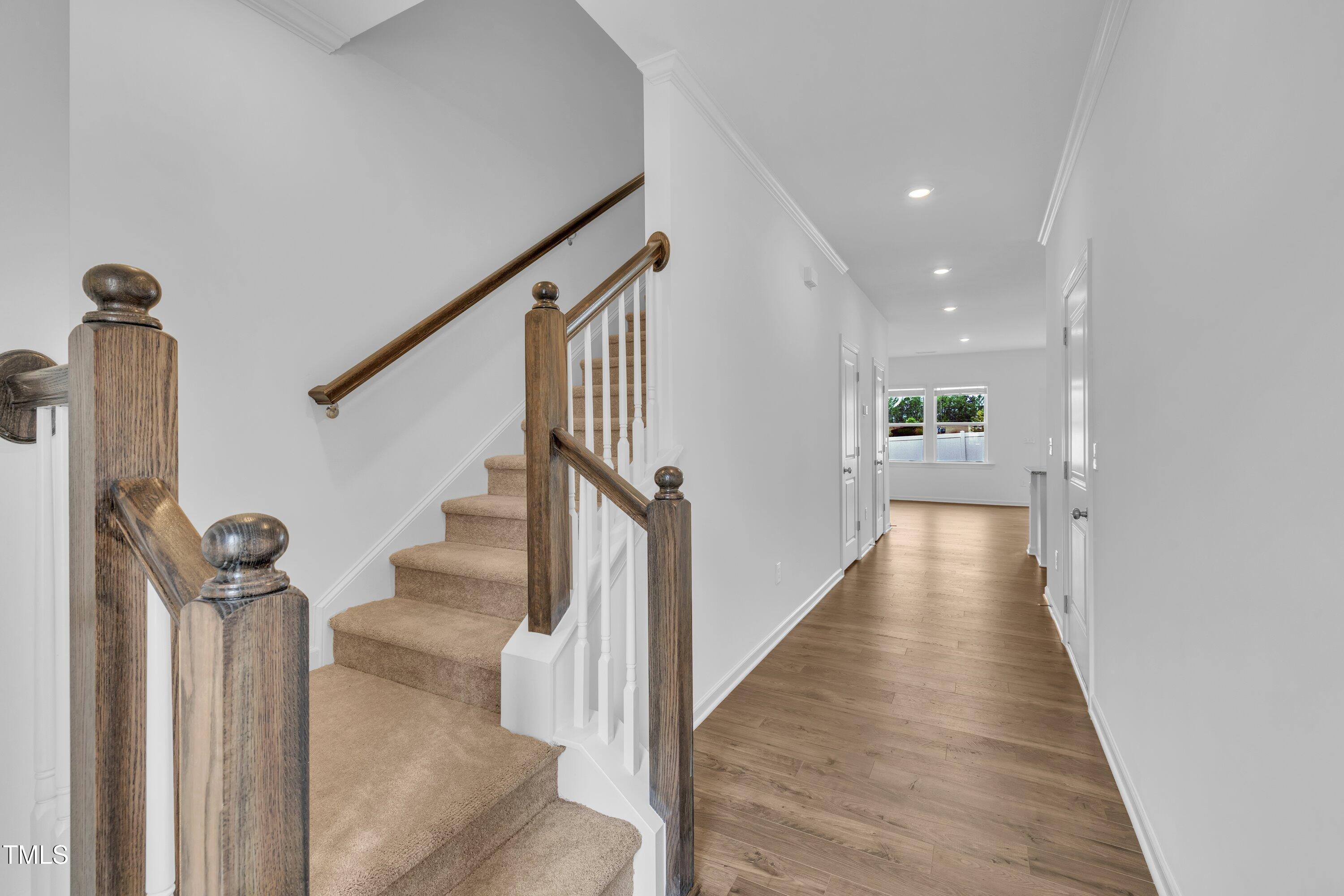 281 Hank Way Angier, NC 27501 - Photo 7 of 39 a view of a hallway with wooden floor and staircase