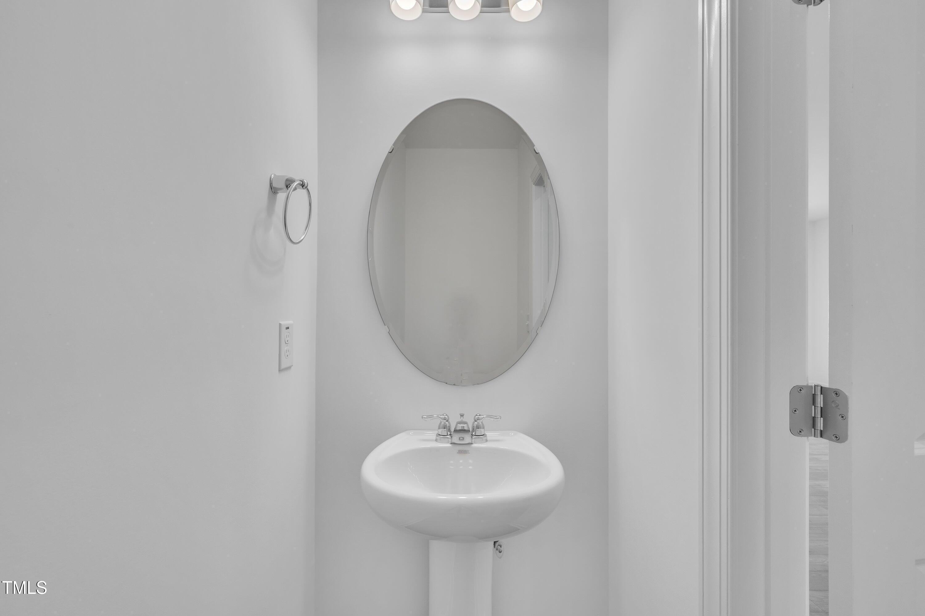 281 Hank Way Angier, NC 27501 - Photo 8 of 39 a bathroom with a sink and a mirror