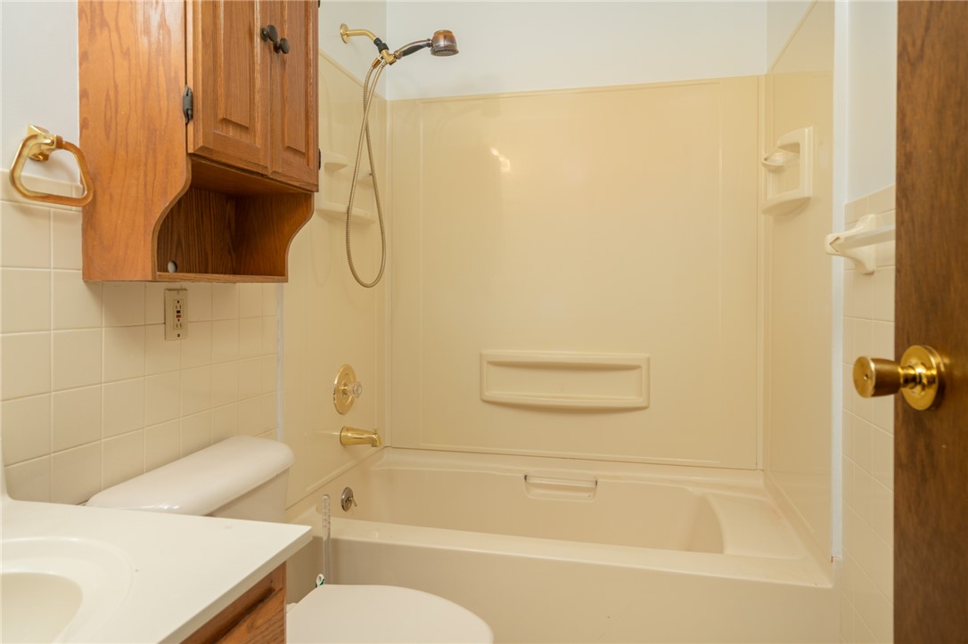 795 Spring Garden Place Dayton, OH 45431 - Photo 27 of 34 This bathroom features a bathtub with an overhead shower and ample storage.