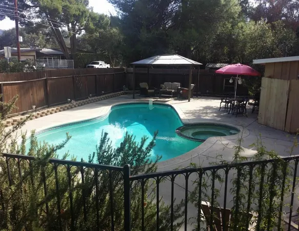 a view of a swimming pool with a patio