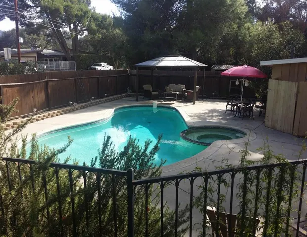 a view of a swimming pool with a patio