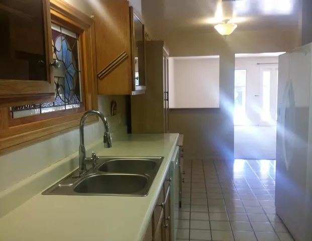 a kitchen with a sink and a stove top oven