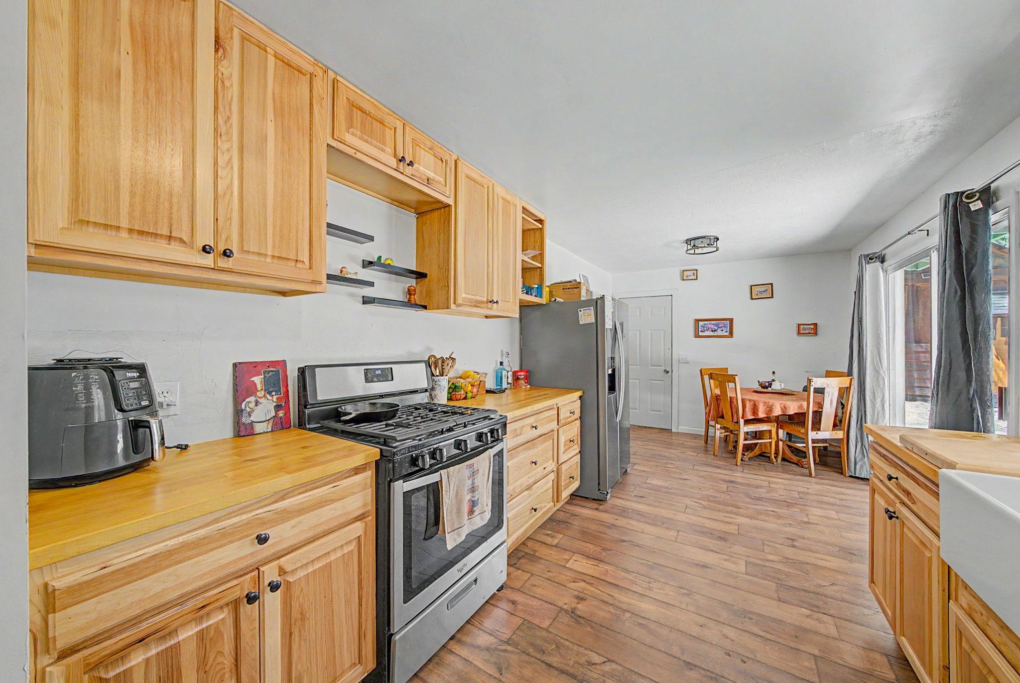 58374 Gill Ranch Road Cromberg, CA 96103 - Photo 27 of 44 a kitchen with stainless steel appliances granite countertop a stove and a refrigerator