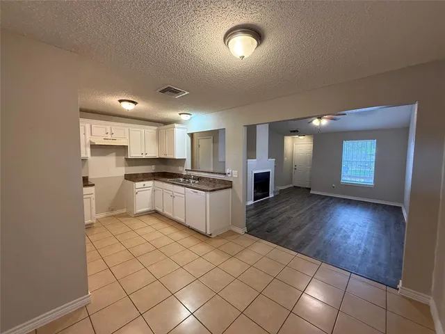 a kitchen with a refrigerator and a stove top oven