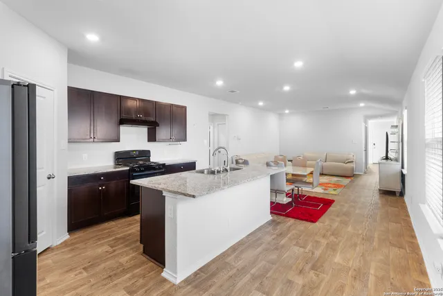 a kitchen with refrigerator and a sink