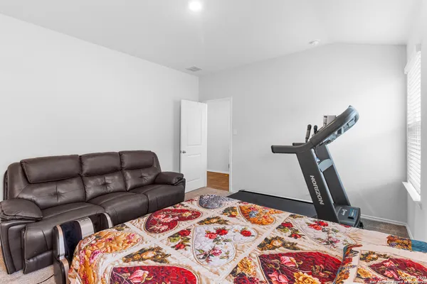 a bedroom with a bed and a couch