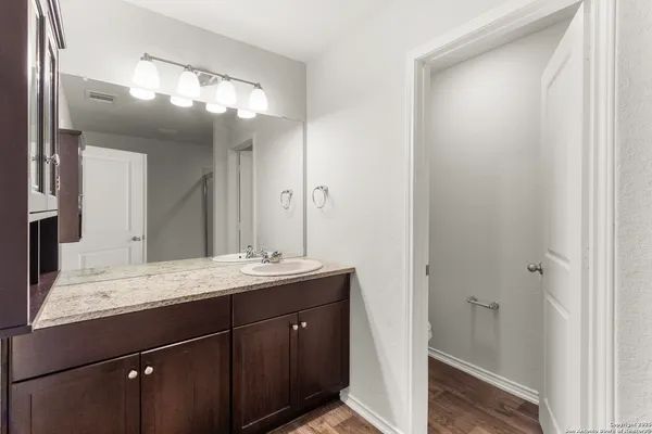 a bathroom with a double vanity sink and a mirror