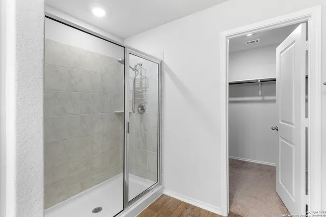 a bathroom with a glass shower door