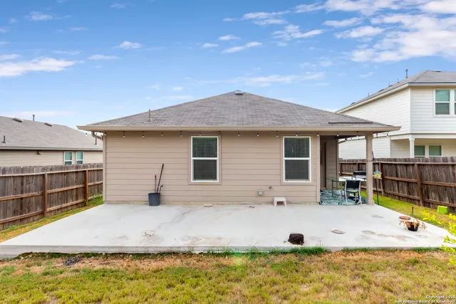 a view of a house with swimming pool and sitting area