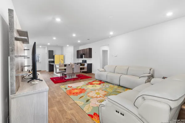 a living room with furniture kitchen and a table