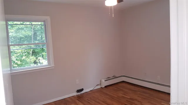 a view of a room with wooden floor and windows