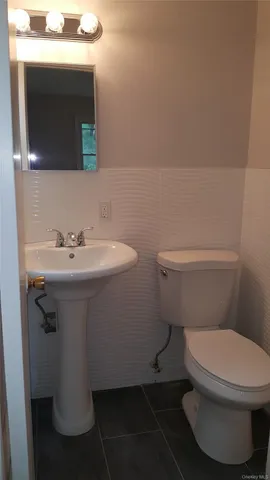 a white toilet sitting next to a bathroom sink