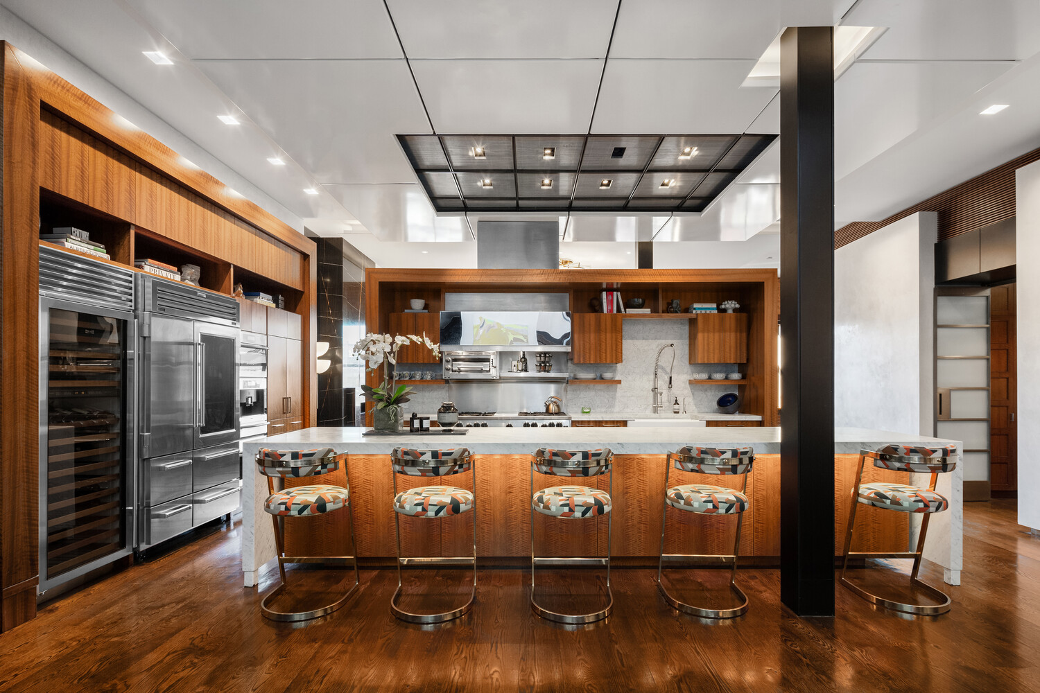 459 West Broadway, Unit PHS Manhattan, NY 10012 - Photo 2 of 17 a view of a room with stainless steel appliances wooden floor dining table and chairs