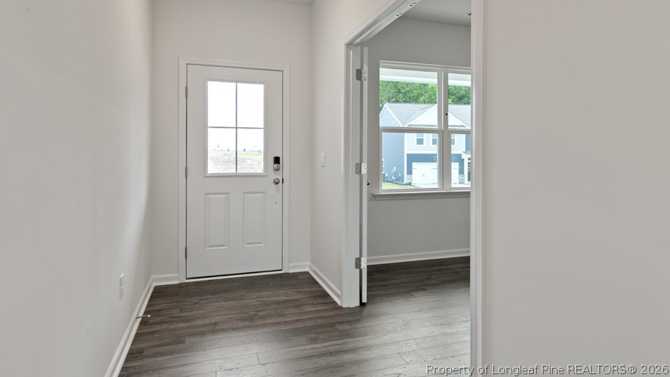 81 Discovery Way Spring Lake, NC 28390 - Photo 2 of 32 an empty room with wooden floor and windows