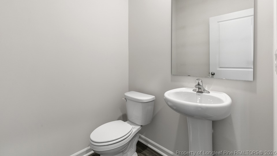 81 Discovery Way Spring Lake, NC 28390 - Photo 26 of 32 a bathroom with a sink a toilet and mirror